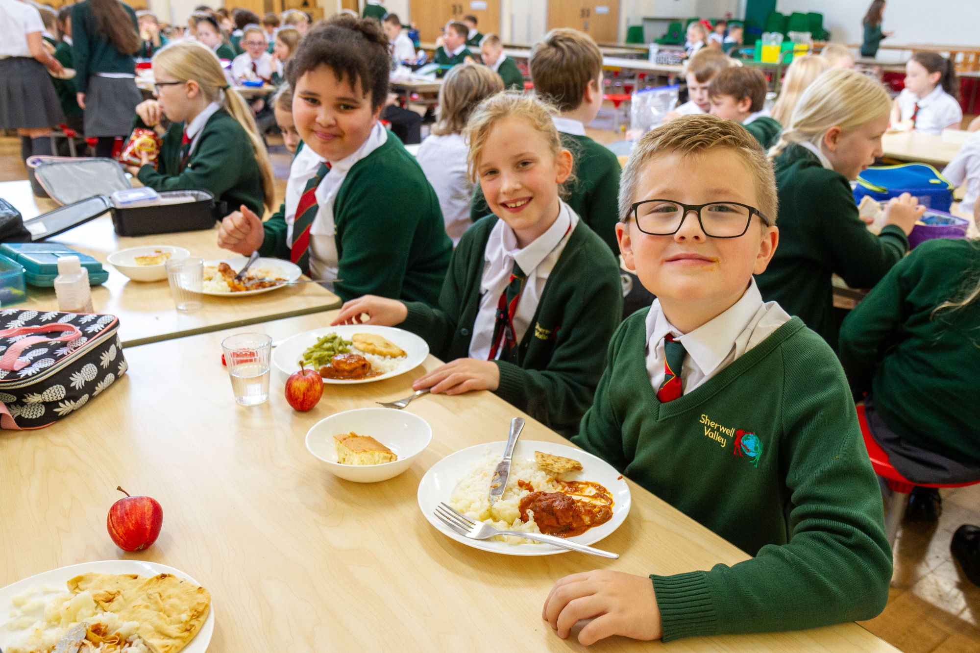 children enjoying school dinner