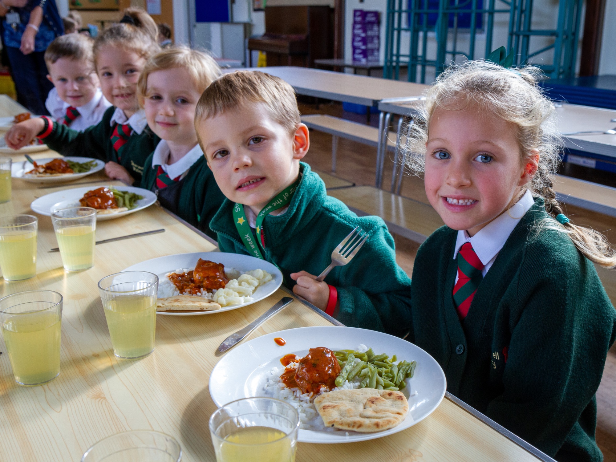 children enjoying school dinner